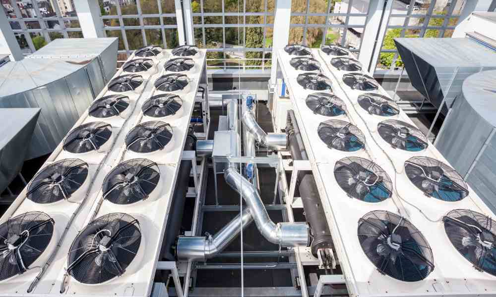  Looking down on a collection of fans attached to a rooftop heating, ventilation, and air conditioning system.